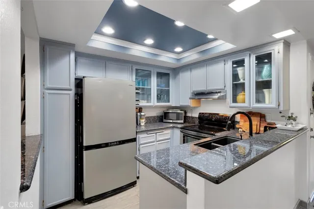 a kitchen with refrigerator a stove a sink and a window