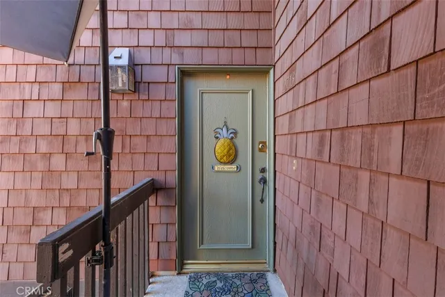 a view of a brick house with wooden fence