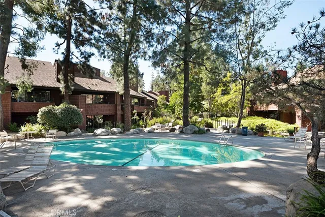 a view of a house with backyard fountain and sitting area