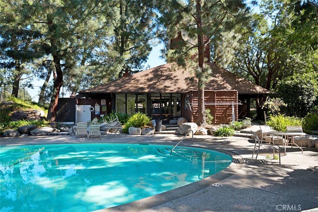 2713 Quail Ridge Circle, Unit 25 Fullerton, CA 92835 - Photo 27 of 30 a front view of a house with swimming pool and chairs