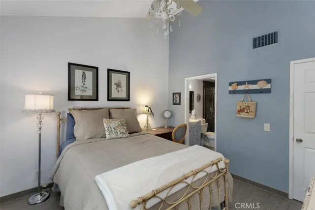 a bedroom with a bed and a lamp on table