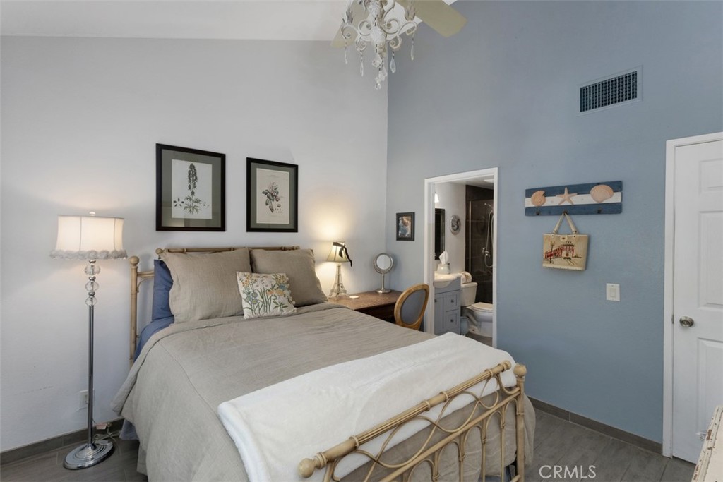 2713 Quail Ridge Circle, Unit 25 Fullerton, CA 92835 - Photo 10 of 30 a bedroom with a bed and a lamp on table