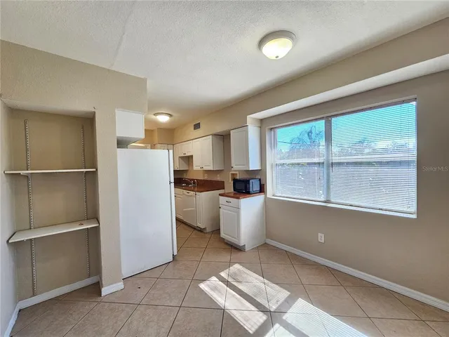 a kitchen with a refrigerator and a window