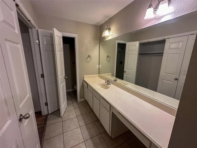 a bathroom with a double vanity sink and mirror