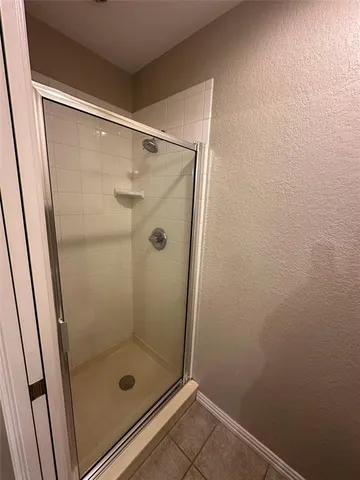 a bathroom with a glass shower door