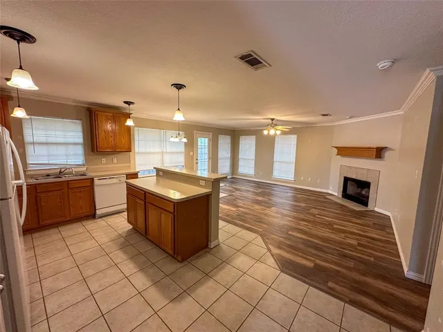 a kitchen with stainless steel appliances kitchen island granite countertop a stove and a sink