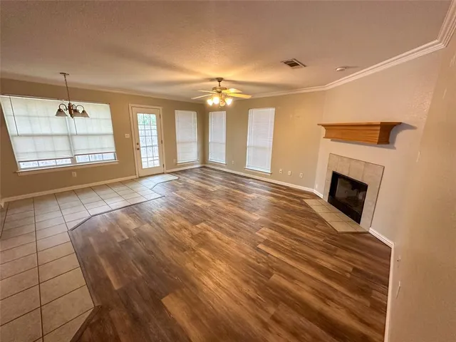 a view of an empty room with a fireplace and a window