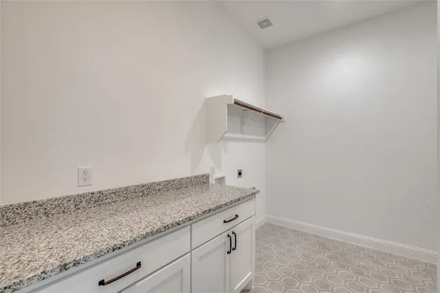 a bathroom with a granite countertop sink and vanity