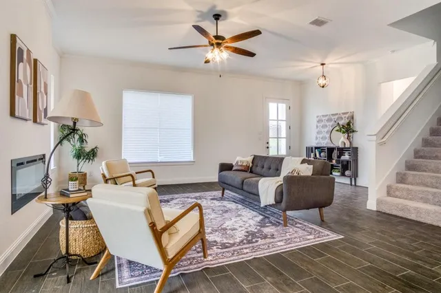 a living room with furniture and a chandelier