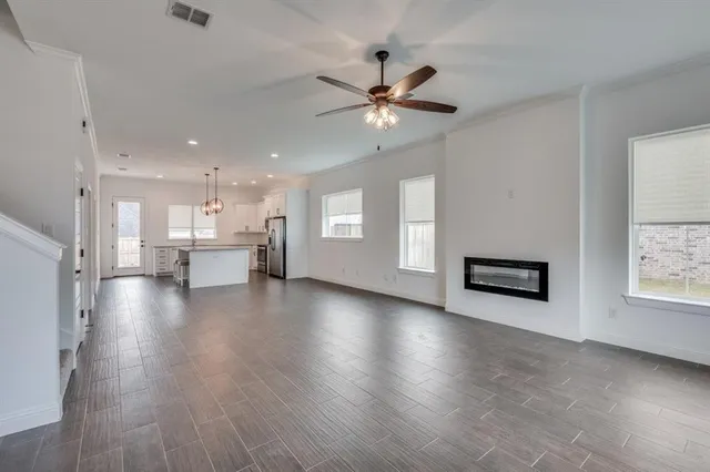 a view of a kitchen with wooden floor and a window