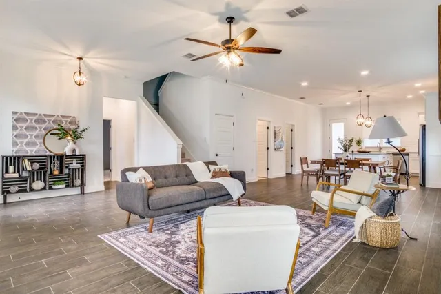 a living room with furniture and wooden floor