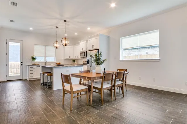 a view of a dining room with furniture and wooden floor