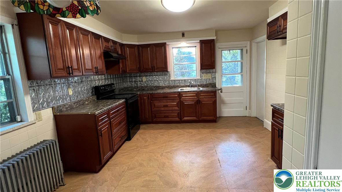 6172 Airport Road Bethlehem, PA 18017 - Photo 2 of 16 a kitchen with stainless steel appliances granite countertop a stove a sink and a refrigerator