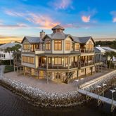 a view of a house with pool and chairs