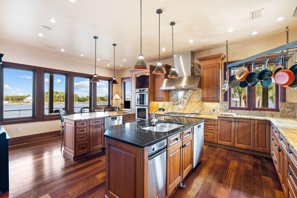 281 Grove Lane Freeport, FL 32439 - Photo 12 of 36 a kitchen with stainless steel appliances granite countertop counter space a sink and wooden floor