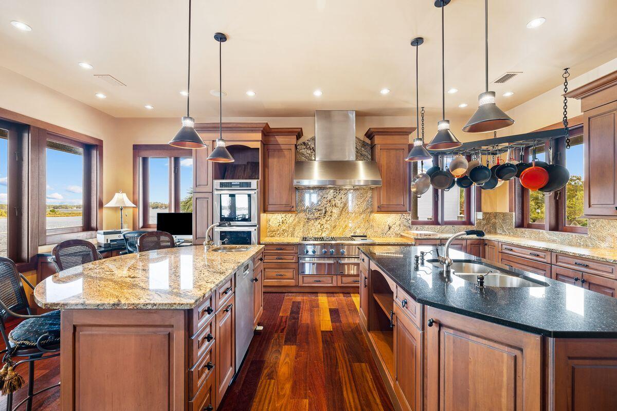 281 Grove Lane Freeport, FL 32439 - Photo 13 of 36 a kitchen with stainless steel appliances granite countertop a sink a stove and a wooden floors