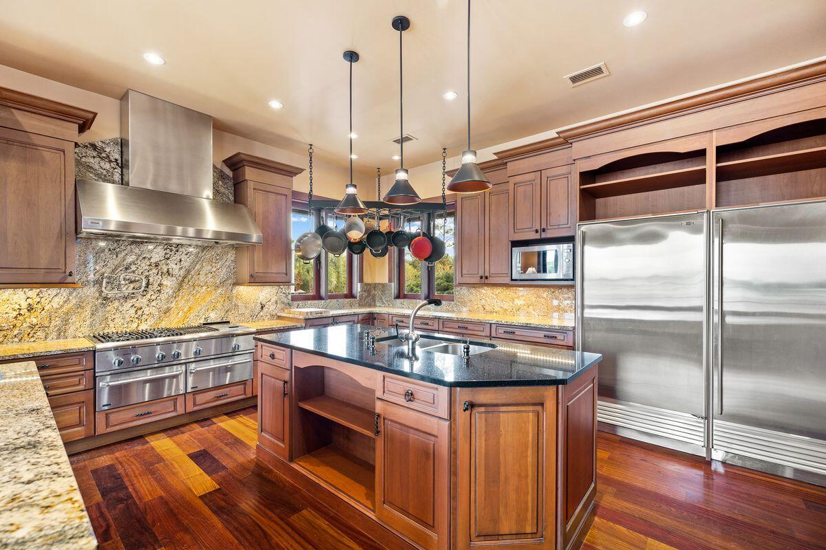 281 Grove Lane Freeport, FL 32439 - Photo 14 of 36 a kitchen with stainless steel appliances granite countertop a sink a stove and a wooden floors