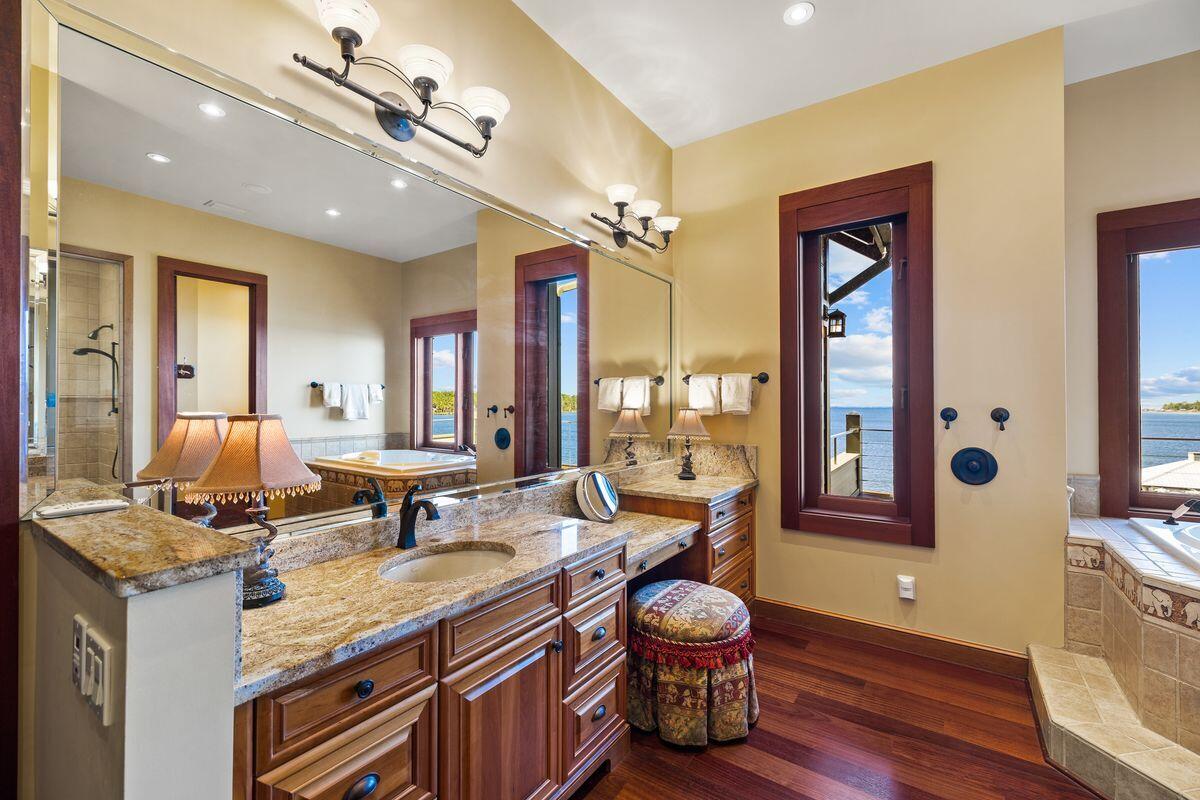 281 Grove Lane Freeport, FL 32439 - Photo 21 of 36 a spacious bathroom with a granite countertop sink and a mirror