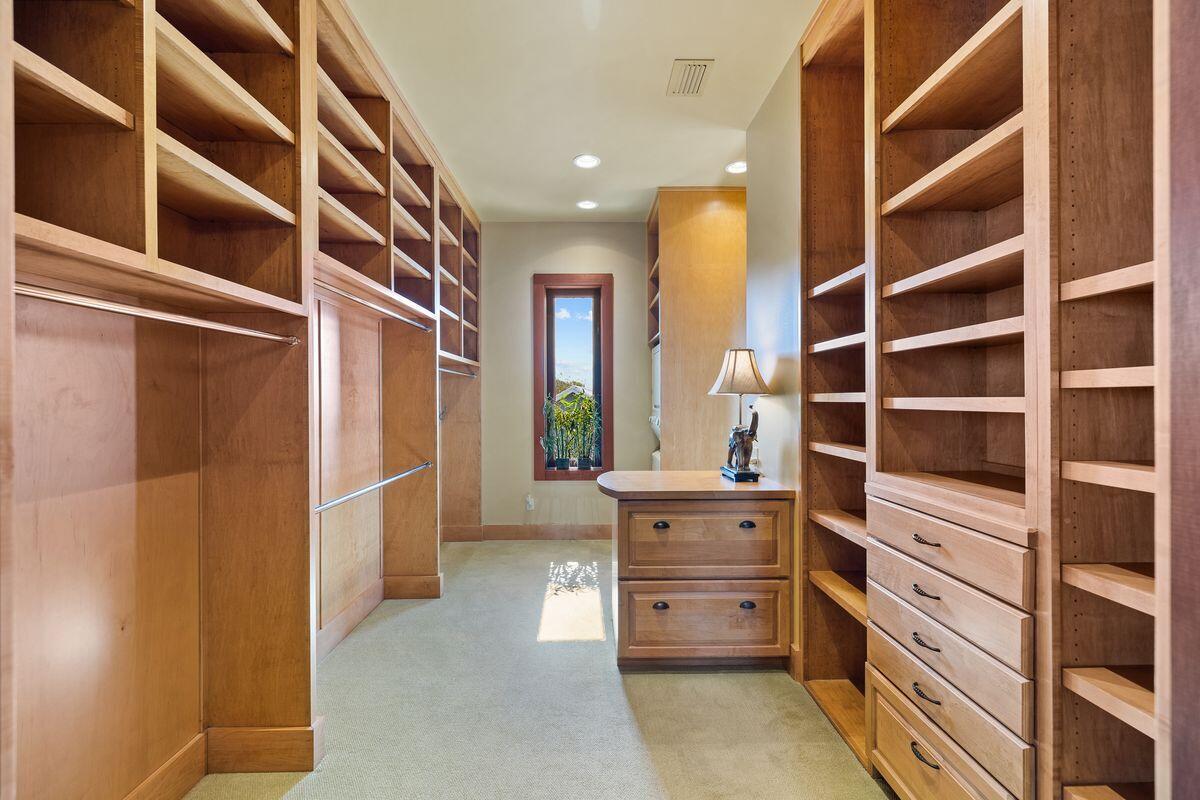 281 Grove Lane Freeport, FL 32439 - Photo 23 of 36 a view of walk in closet with clothes and shoes