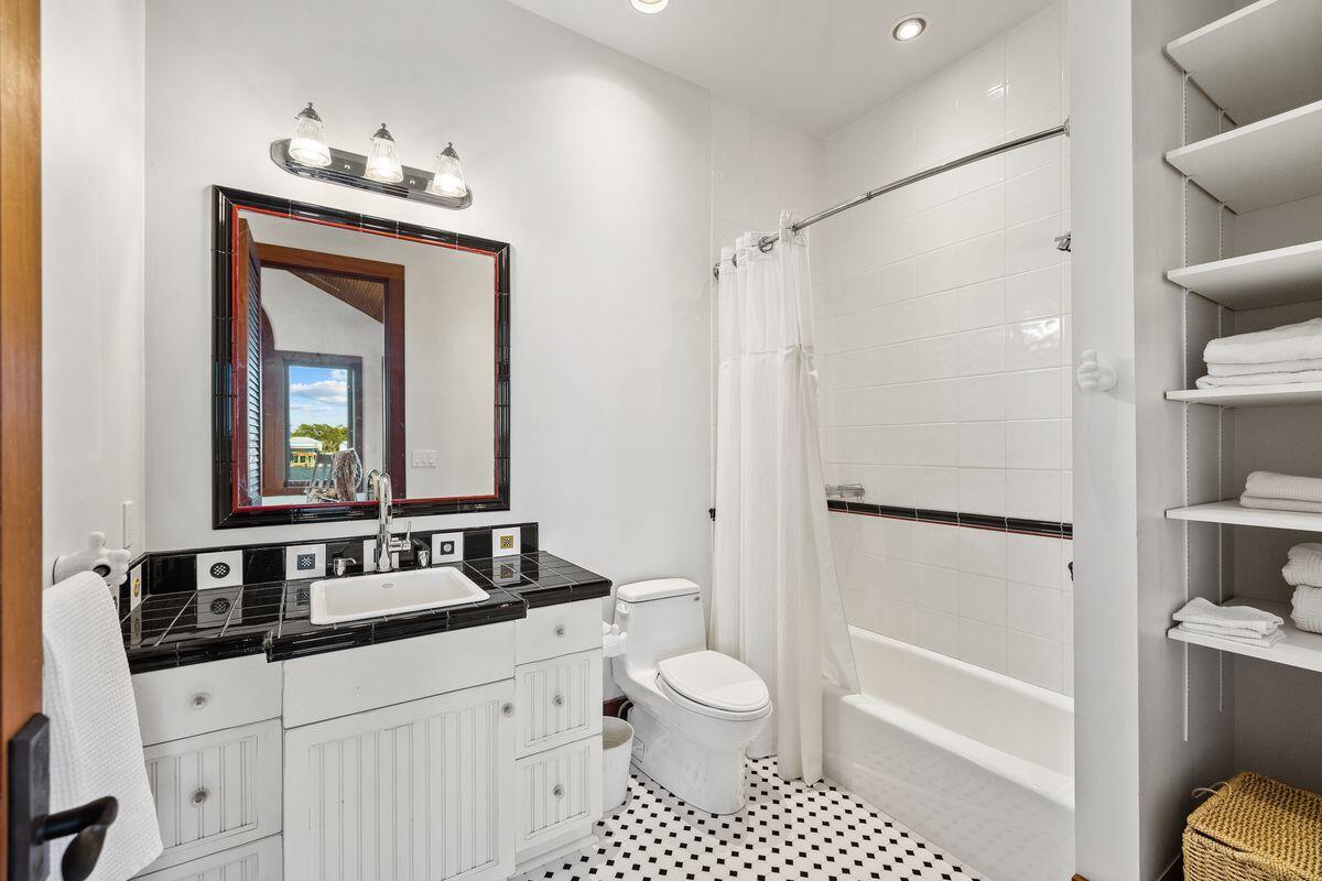 281 Grove Lane Freeport, FL 32439 - Photo 27 of 36 a bathroom with a sink a toilet and a mirror