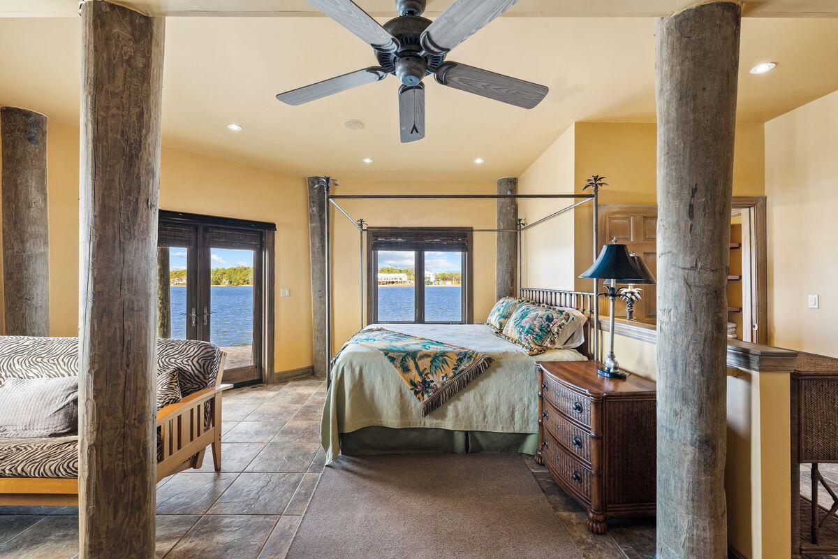 281 Grove Lane Freeport, FL 32439 - Photo 31 of 36 a bedroom with a bed and a chandelier