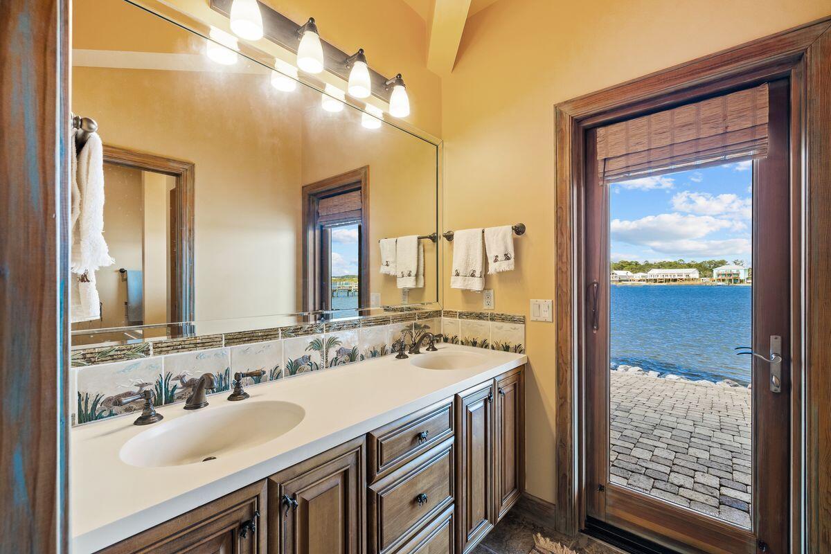 281 Grove Lane Freeport, FL 32439 - Photo 32 of 36 a bathroom with a sink vanity and a mirror