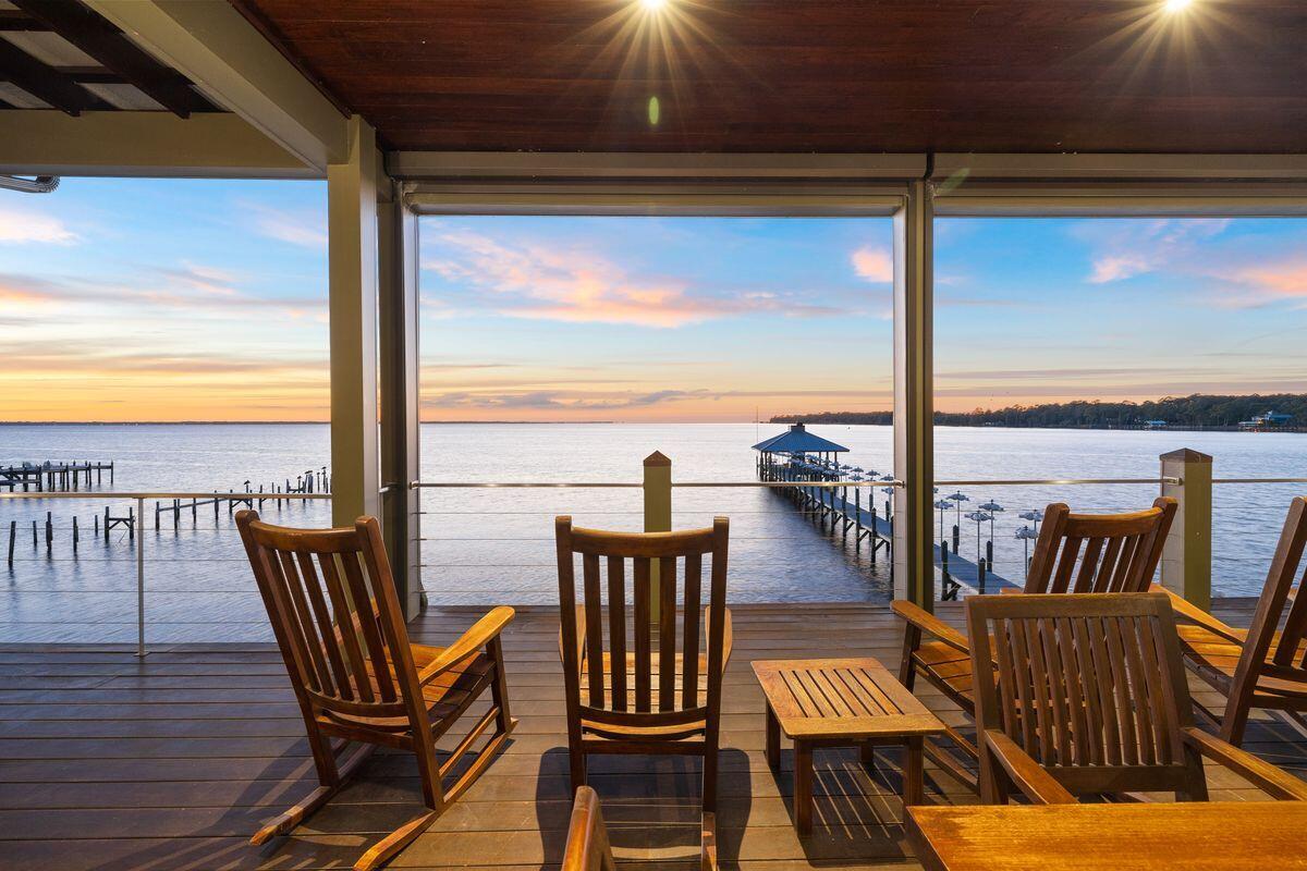 281 Grove Lane Freeport, FL 32439 - Photo 4 of 36 a view of a balcony with furniture and wooden floor