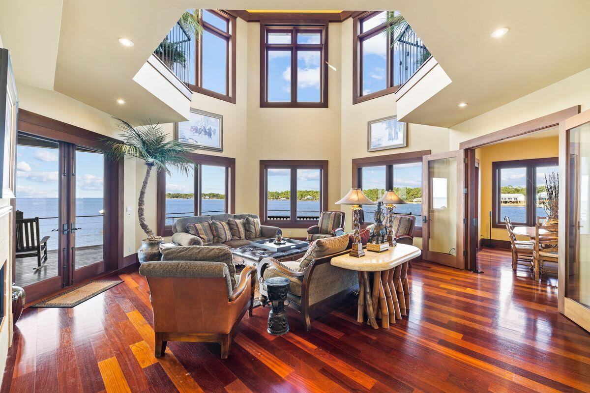 281 Grove Lane Freeport, FL 32439 - Photo 6 of 36 a view of a dining room with furniture a chandelier and wooden floor