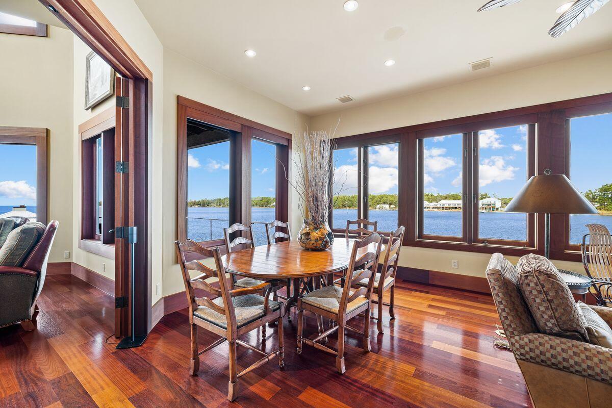 281 Grove Lane Freeport, FL 32439 - Photo 10 of 36 a view of a dining room with furniture window and wooden floor
