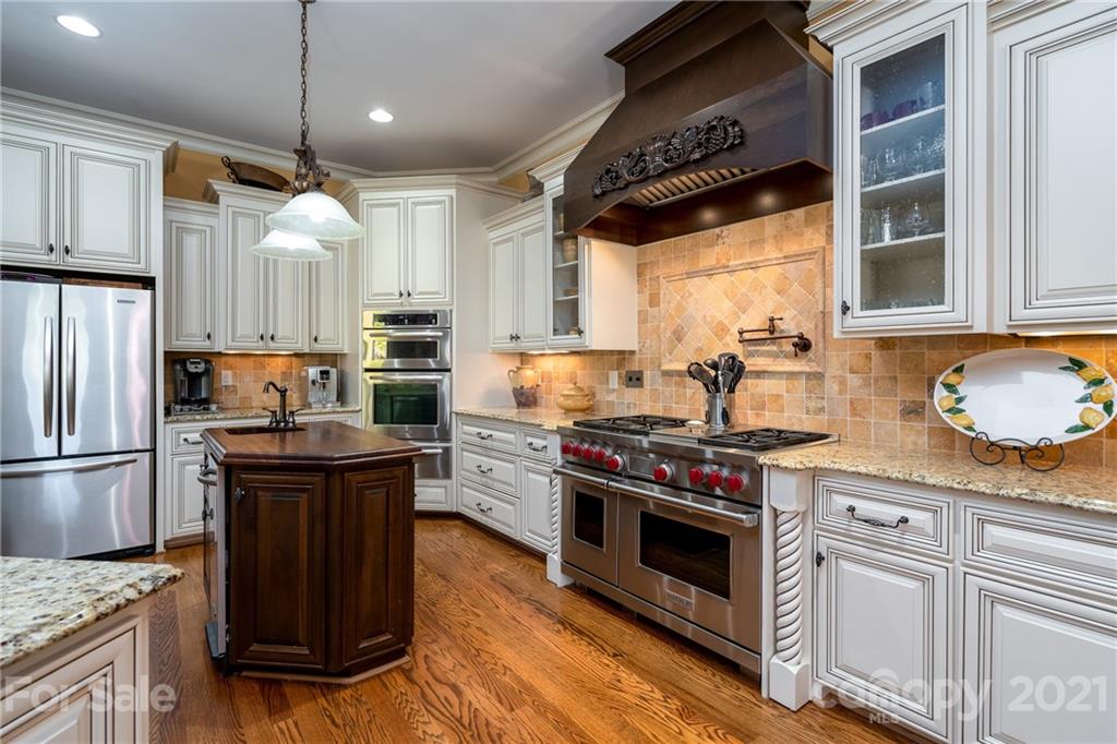 2341 Valelake Road York, SC 29745 - Photo 14 of 48 a kitchen with granite countertop a stove and a refrigerator