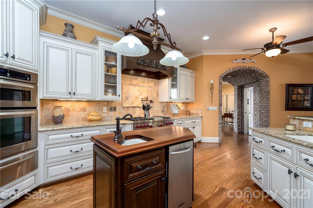 2341 Valelake Road York, SC 29745 - Photo 16 of 48 a kitchen with cabinets a chandelier and stainless steel appliances
