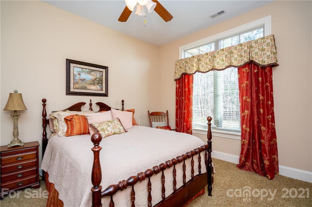 2341 Valelake Road York, SC 29745 - Photo 30 of 48 a bedroom with a bed and a chandelier
