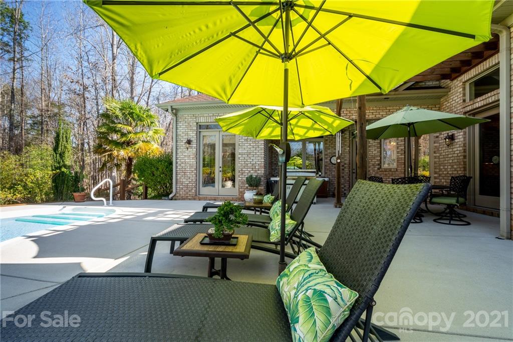 2341 Valelake Road York, SC 29745 - Photo 41 of 48 a view of a patio with a table and chairs under an umbrella