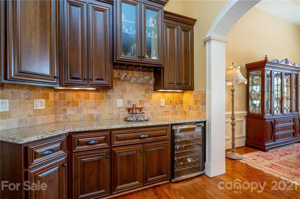 2341 Valelake Road York, SC 29745 - Photo 10 of 48 a kitchen with granite countertop wooden cabinets and a wooden floor