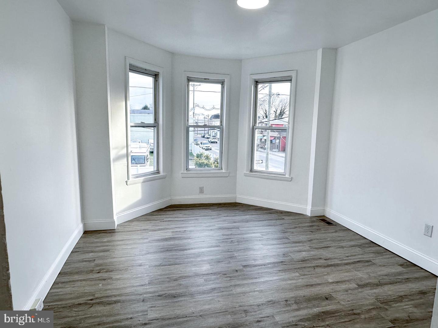 255 3rd Street Gloucester City, NJ 08030 - Photo 15 of 35 an empty room with wooden floor and windows