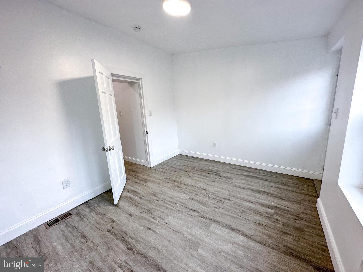 255 3rd Street Gloucester City, NJ 08030 - Photo 18 of 35 an empty room with wooden floor and window