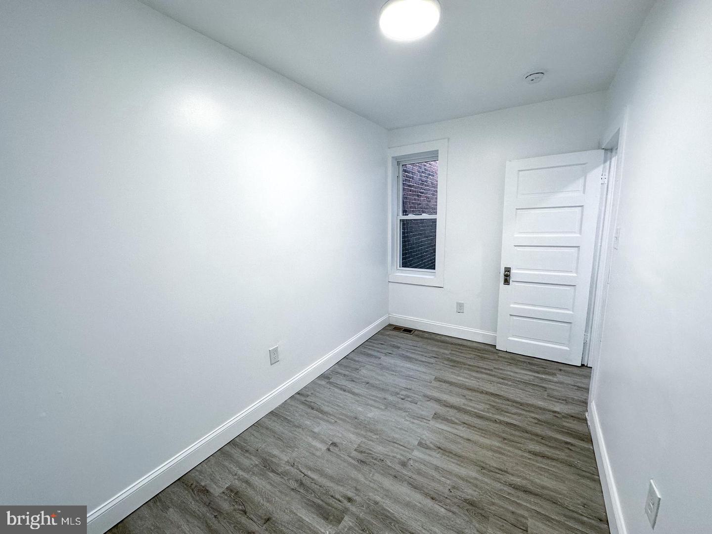 255 3rd Street Gloucester City, NJ 08030 - Photo 19 of 35 a view of an empty room with wooden floor and a window