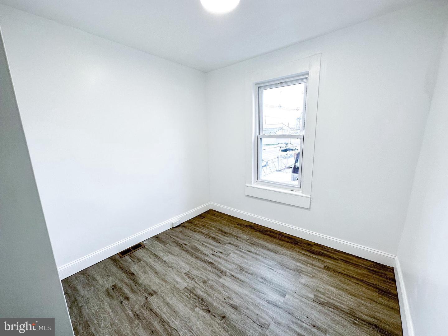 255 3rd Street Gloucester City, NJ 08030 - Photo 20 of 35 a view of an empty room with wooden floor and a window