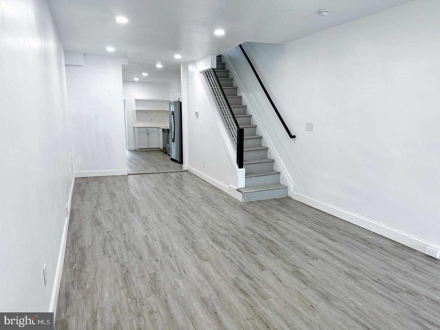 255 3rd Street Gloucester City, NJ 08030 - Photo 26 of 35 wooden floor in an empty room with a kitchen