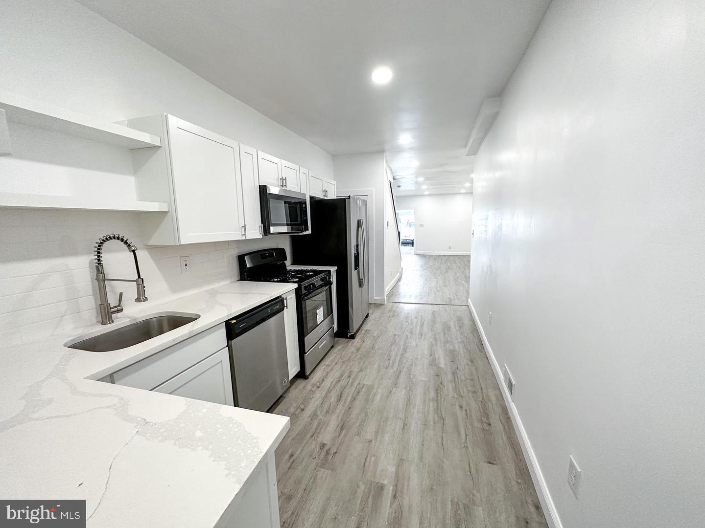 255 3rd Street Gloucester City, NJ 08030 - Photo 31 of 35 a kitchen with a sink a counter top space stainless steel appliances and cabinets