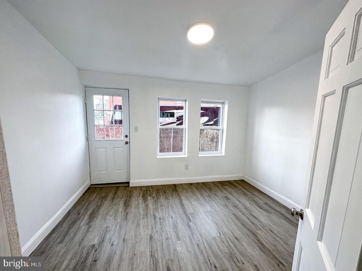 255 3rd Street Gloucester City, NJ 08030 - Photo 32 of 35 an empty room with wooden floor and windows