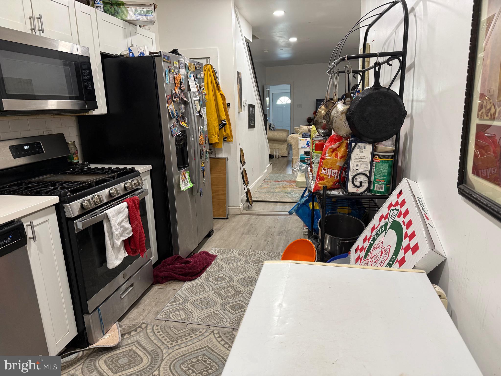 255 3rd Street Gloucester City, NJ 08030 - Photo 10 of 35 a living room with stainless steel appliances furniture and a fireplace