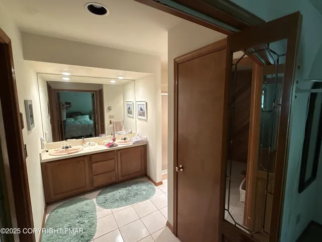 a large bathroom with a glass door shower and sink