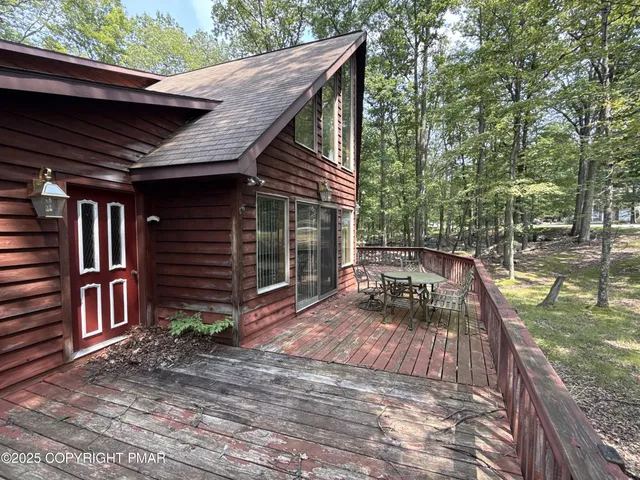 a view of backyard with barbeque grill and wooden fence