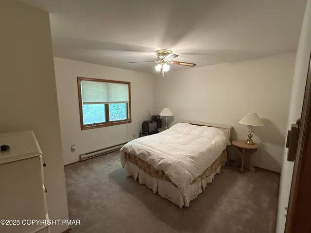 a spacious bedroom with a bed and a window