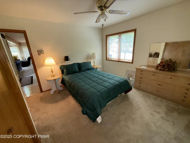 a bedroom with a bed and a dresser