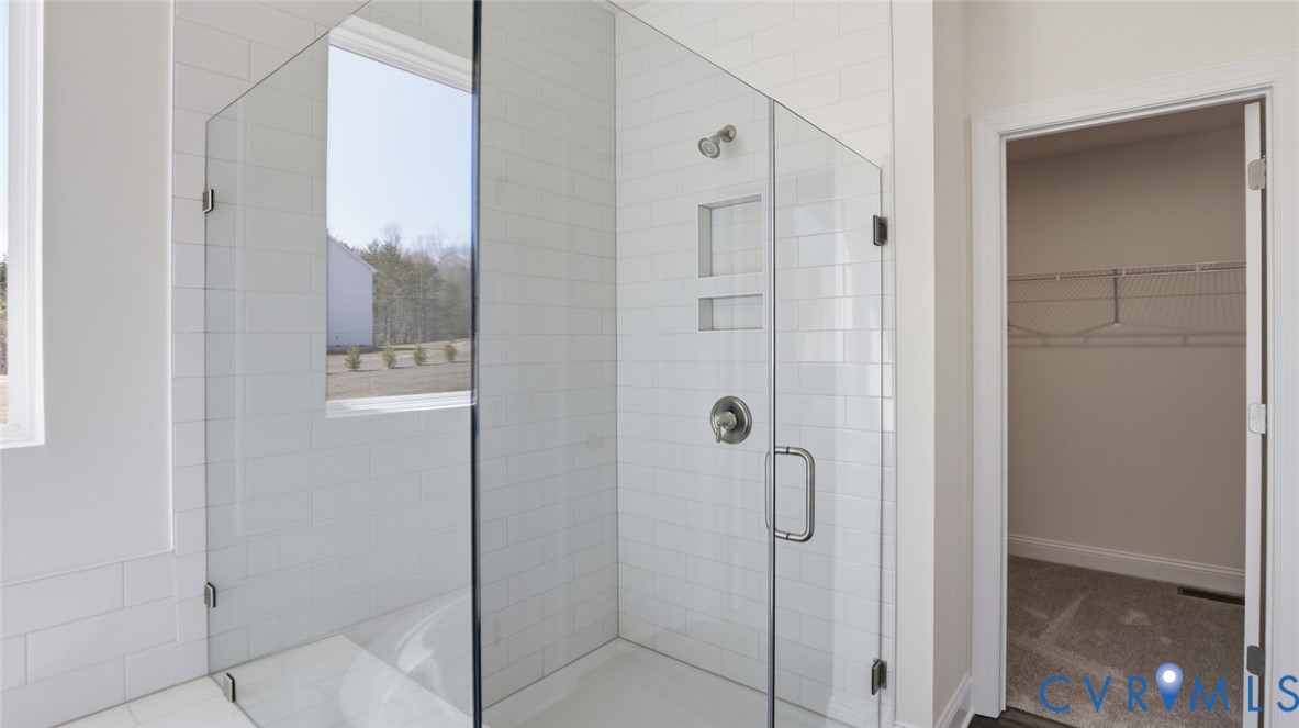 3726 Rocketts Ridge Drive Goochland, VA 23063 - Photo 22 of 38 The first-floor primary suite offers a luxurious r