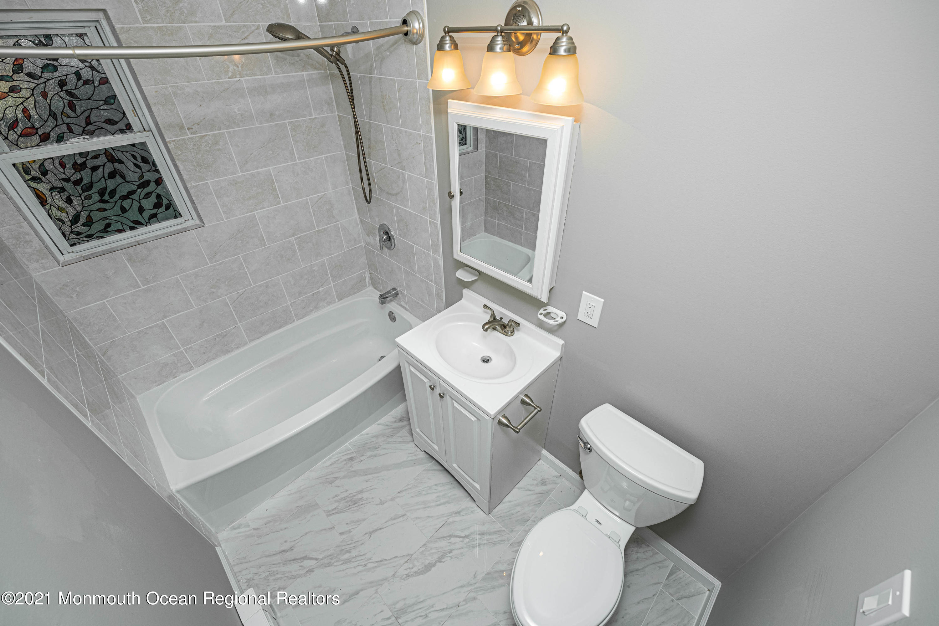 59 Stonehurst Boulevard, Unit B Freehold, NJ 07728 - Photo 12 of 25 a bathroom with a toilet sink and shower