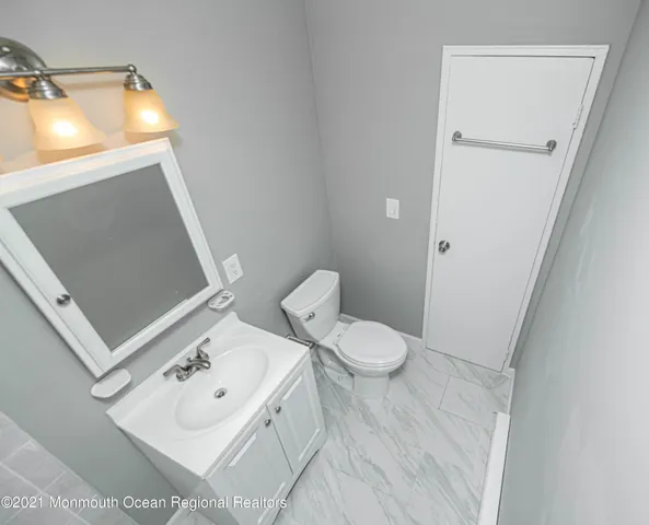 a white toilet sitting next to a bathroom sink