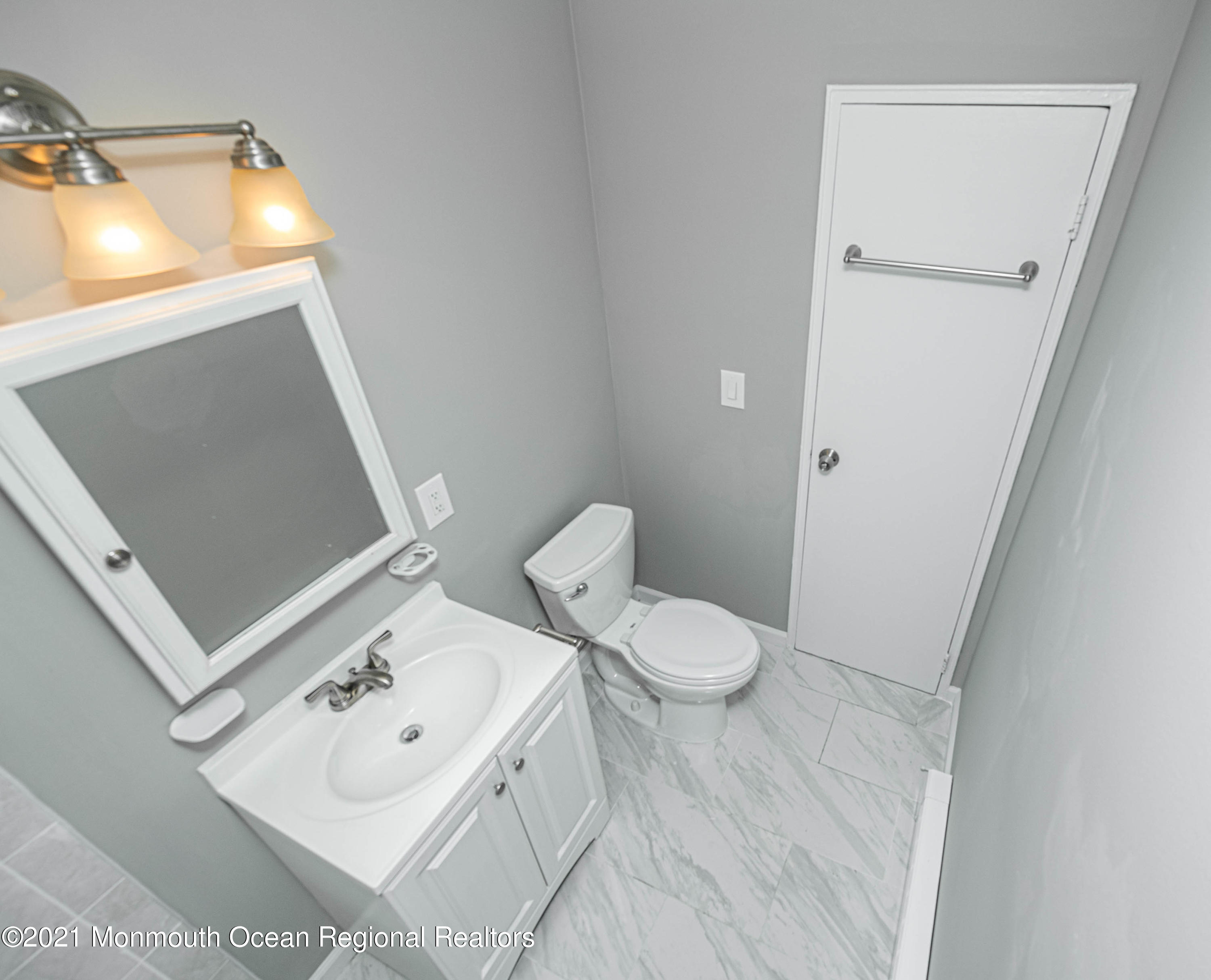 59 Stonehurst Boulevard, Unit B Freehold, NJ 07728 - Photo 13 of 25 a white toilet sitting next to a bathroom sink
